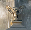 2  hour glass and skull high above the tomb 