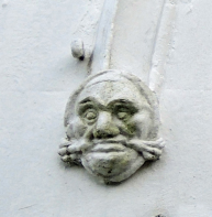 Coade stone foliate head on left hand side of doorway