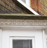Nailhead frieze above windows of eight terraced houses in Pound Lane
