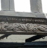 Carved bressumers on jetty sill – Burgate