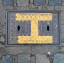 metal cover in St Peter's Street outside the St Peter's C of E church